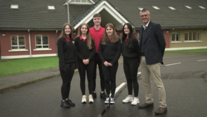 Aodan Mac Gearailt principal of Meán Scoil Nua an Leith-Triúigh with students