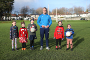 Dr Stephen Behan DCU with children from Na Fianna GAA Club, who are participating in the Moving Well Being Well Project