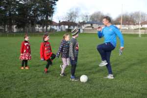 Dr Stephen Behan DCU with children from Na Fianna GAA Club, who are participating in the Moving Well Being Well Project