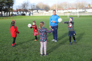 Dr Stephen Behan DCU with children from Na Fianna GAA Club, who are participating in the Moving Well Being Well Project